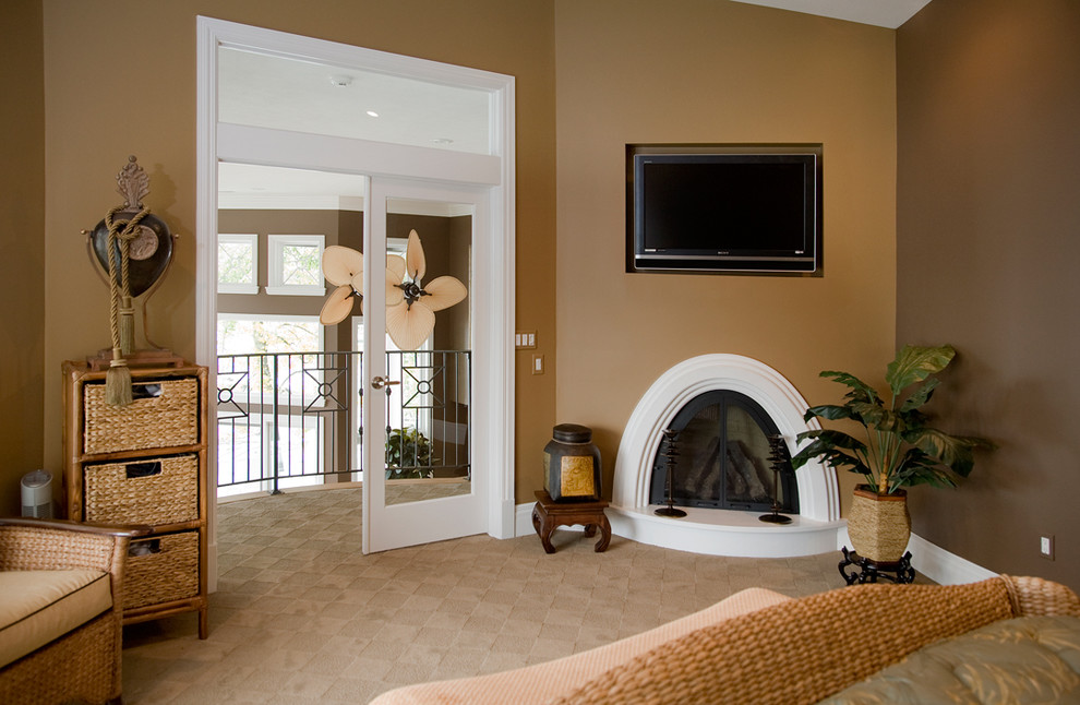 Mediterranean master bedroom in Other with carpet, a standard fireplace and a wooden fireplace surround.