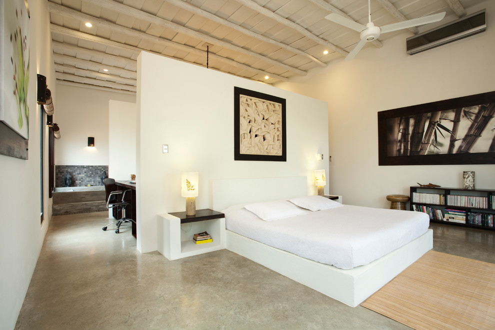 Photo of a modern loft bedroom in Other with concrete flooring.