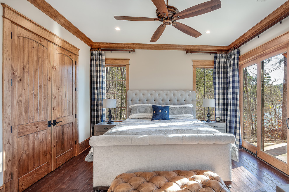 Mittelgroßes Rustikales Hauptschlafzimmer mit beiger Wandfarbe, braunem Holzboden und braunem Boden