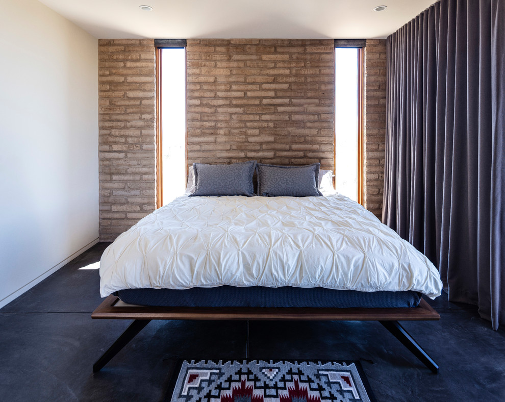 シアトルにある小さなサンタフェスタイルのおしゃれな主寝室 (白い壁、コンクリートの床、グレーの床) のインテリア