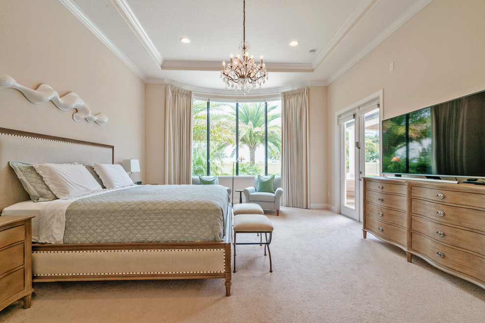 Photo of a traditional master bedroom in Orange County with beige walls, carpet and beige floors.