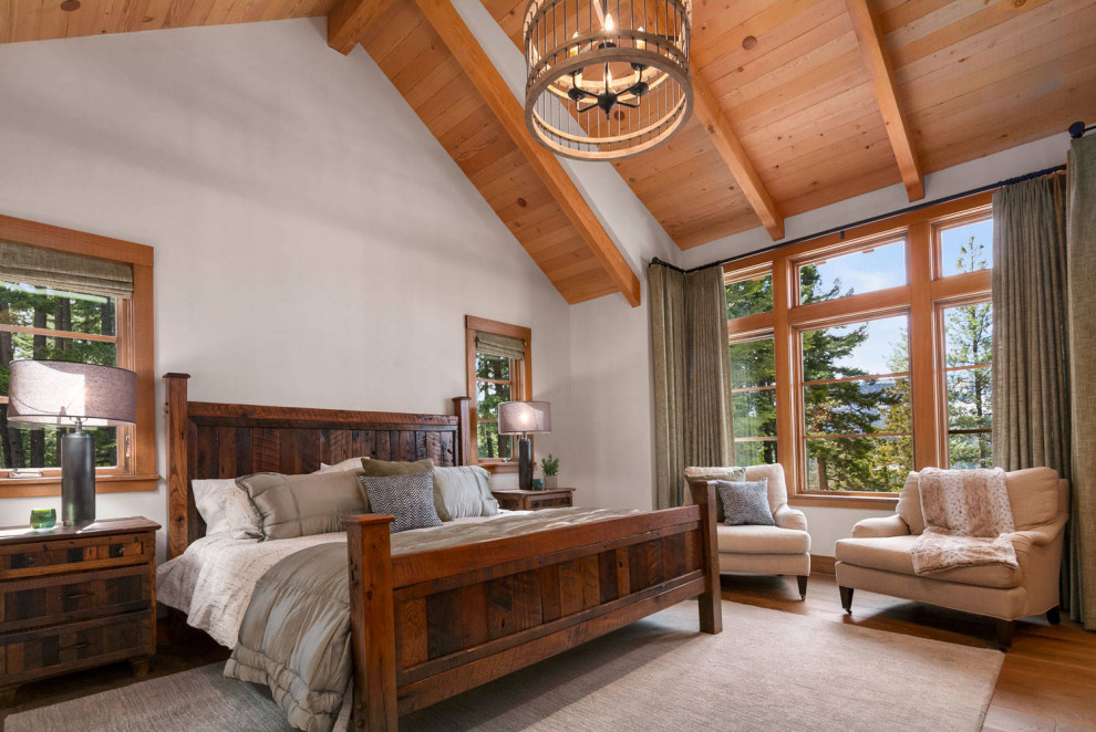 Inspiration for a mid-sized timeless medium tone wood floor bedroom remodel in Seattle with beige walls, a standard fireplace and a metal fireplace