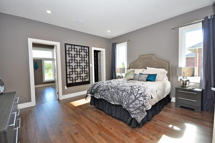 Mittelgroßes Modernes Schlafzimmer mit grauer Wandfarbe, dunklem Holzboden und braunem Boden in Toronto