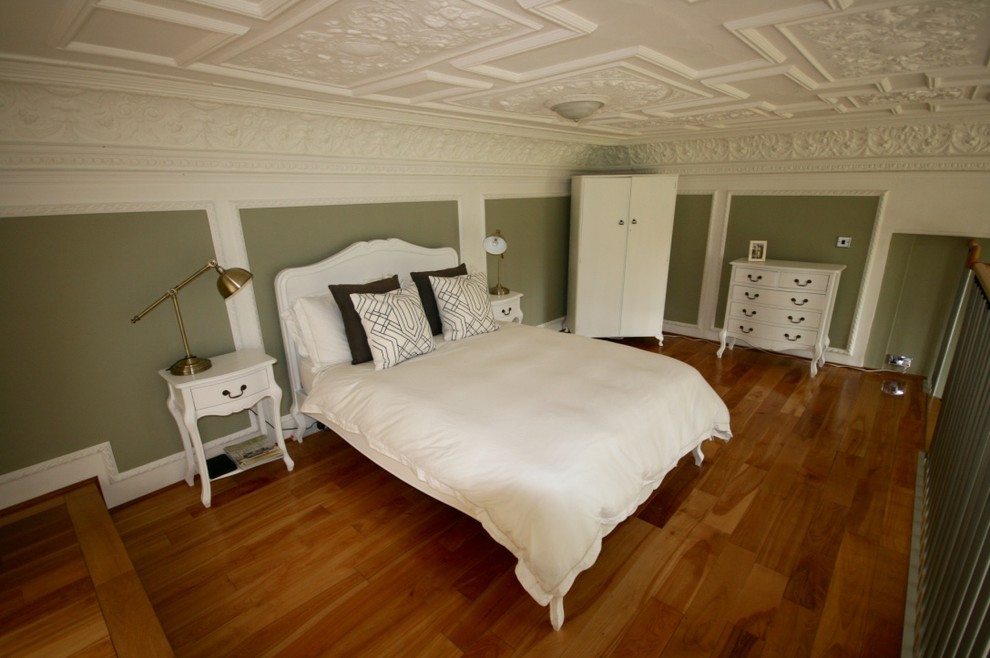 Photo of a medium sized victorian mezzanine bedroom in Other with green walls and light hardwood flooring.