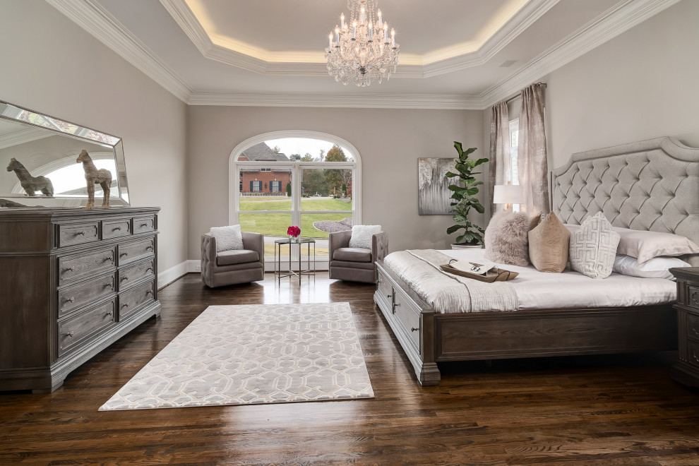This is an example of a large classic master and grey and brown bedroom in Birmingham with grey walls, medium hardwood flooring and brown floors.