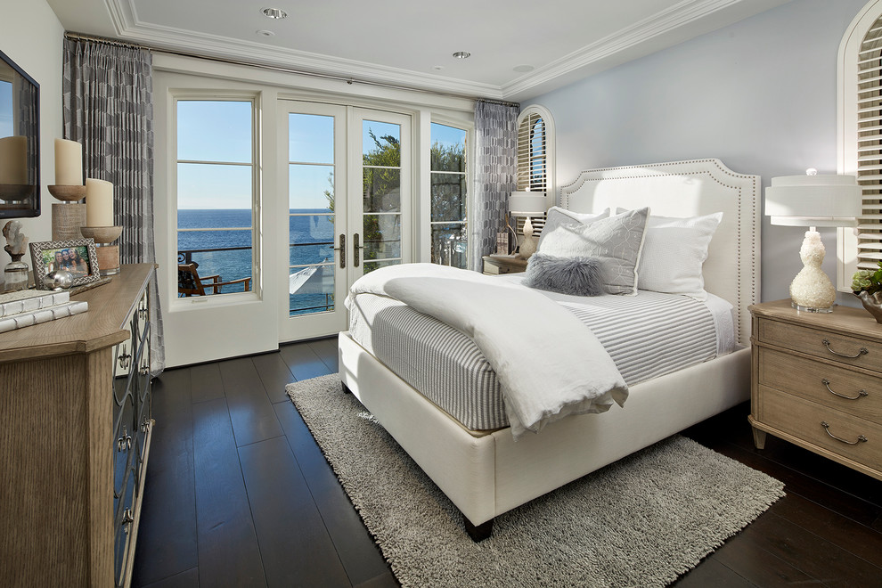 Inspiration for a medium sized coastal guest bedroom in Orange County with dark hardwood flooring, grey walls, no fireplace and brown floors.