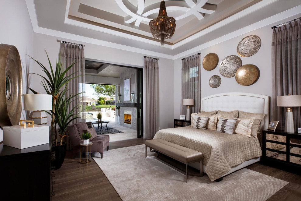 Large traditional master bedroom in Miami with grey walls, dark hardwood flooring, no fireplace and brown floors.