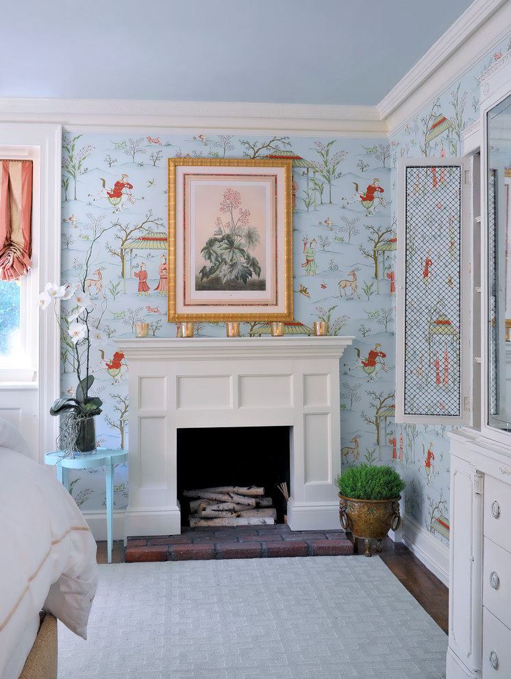 Design ideas for a medium sized traditional guest bedroom in New York with blue walls, carpet, a standard fireplace and a wooden fireplace surround.