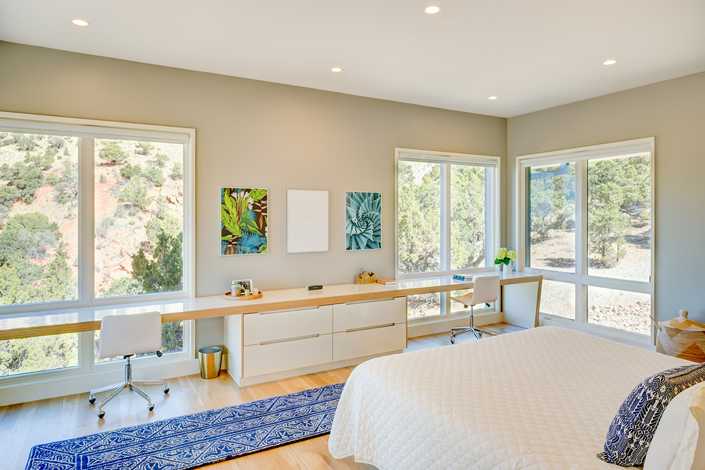 Modernes Schlafzimmer mit beiger Wandfarbe, braunem Holzboden und braunem Boden in Sonstige