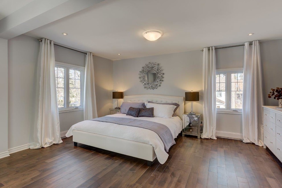 Photo of a medium sized contemporary master bedroom in Montreal with grey walls, medium hardwood flooring and brown floors.