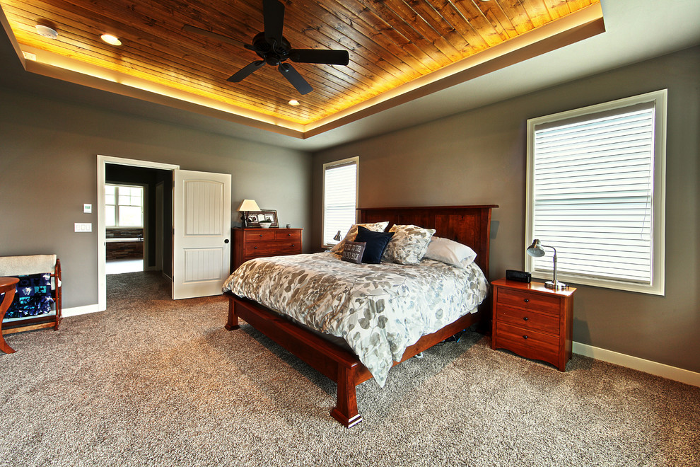 Example of a transitional master carpeted bedroom design in Grand Rapids with gray walls