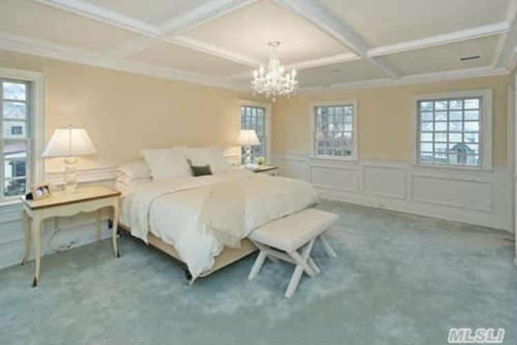 Inspiration for a large transitional master carpeted bedroom remodel in New York with beige walls and no fireplace