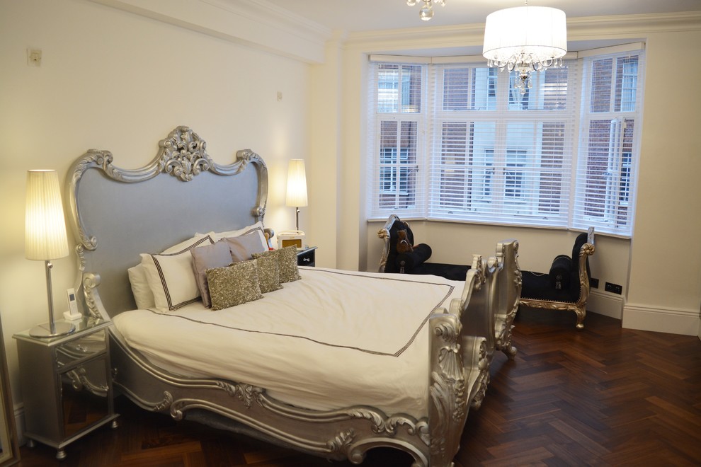 Example of a mid-sized trendy dark wood floor bedroom design in London with white walls