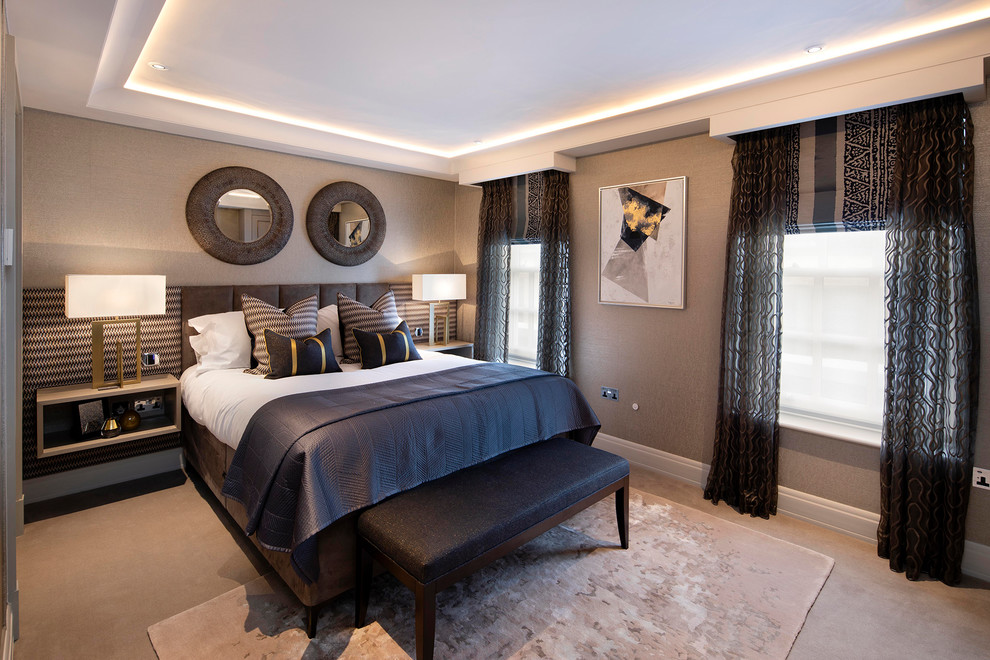 Design ideas for a contemporary master bedroom in London with beige walls, carpet and beige floors.