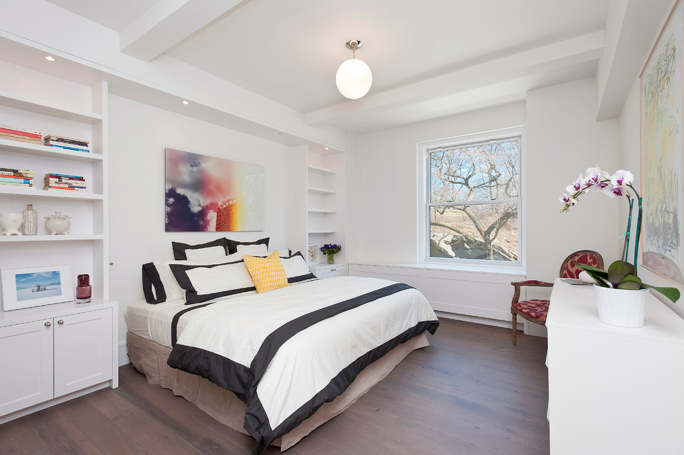 Bedroom - small modern medium tone wood floor bedroom idea in New York with white walls and no fireplace