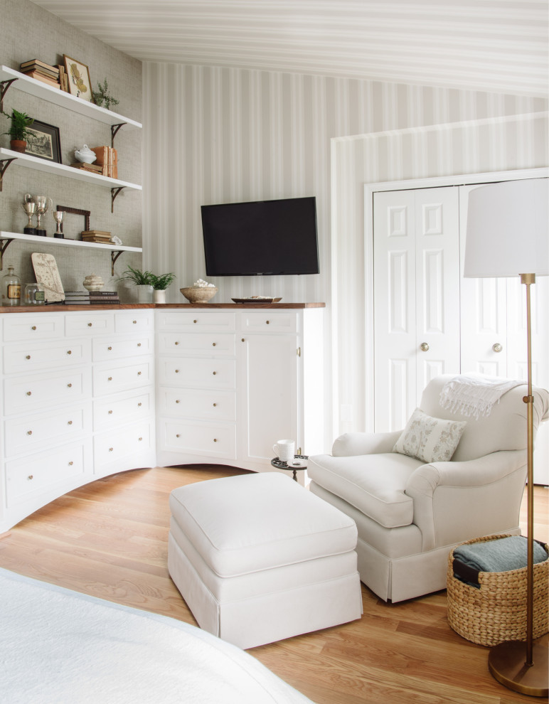 Diseño de dormitorio principal clásico de tamaño medio sin chimenea con paredes beige, suelo de madera clara y suelo beige