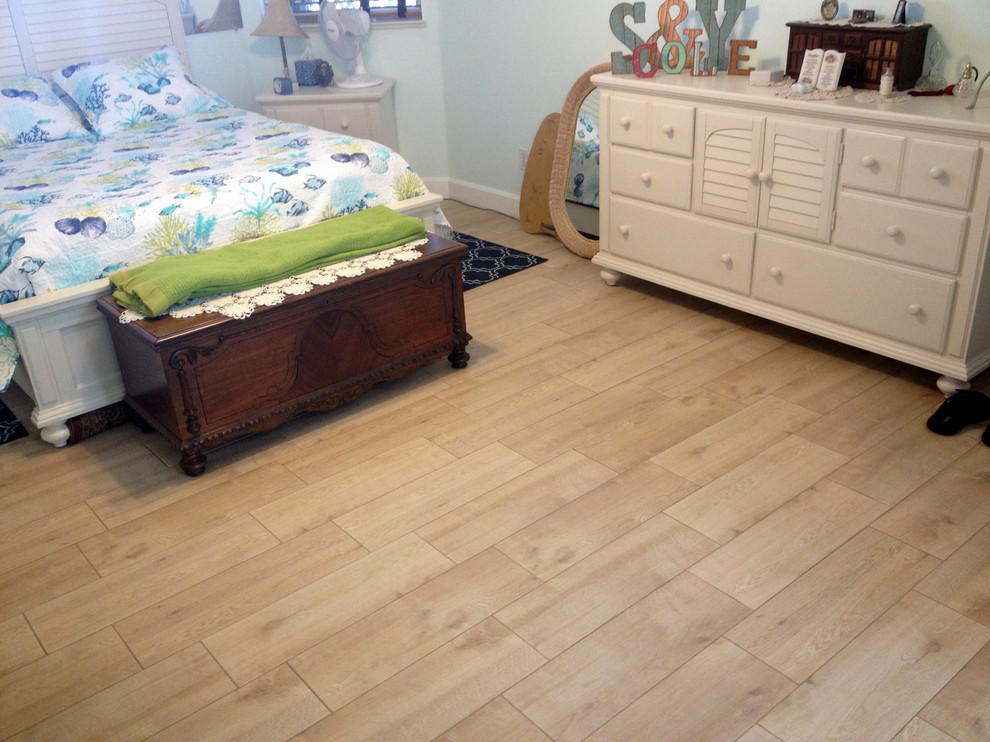 Photo of a medium sized nautical master bedroom in Orlando with blue walls, ceramic flooring and beige floors.