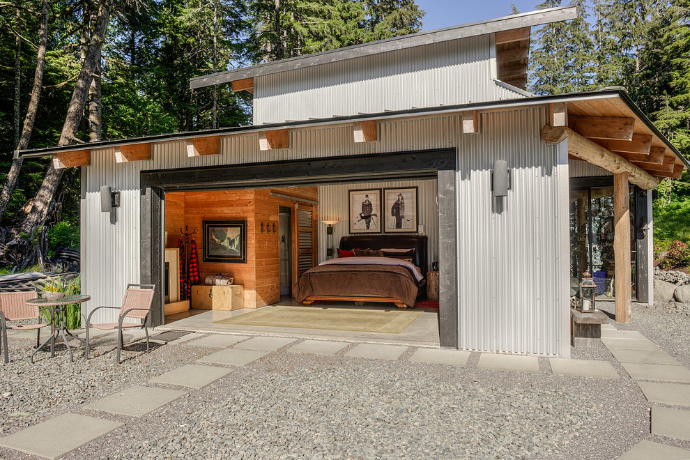 This is an example of a contemporary guest bedroom in Vancouver with concrete flooring.