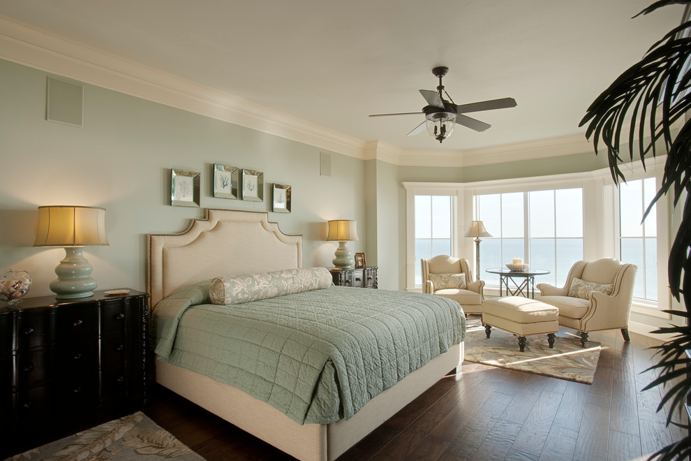 Photo of a coastal bedroom in Other with green walls, dark hardwood flooring and brown floors.