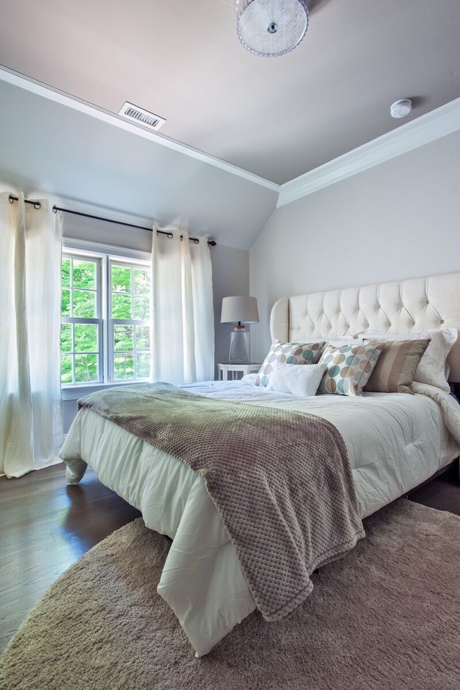Modelo de habitación de invitados clásica renovada pequeña con paredes beige y suelo de madera oscura