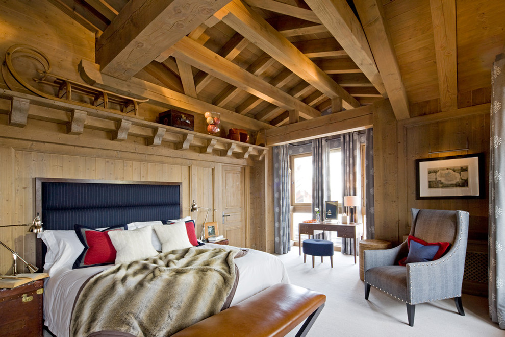 Photo of a large rustic master bedroom in London with no fireplace.