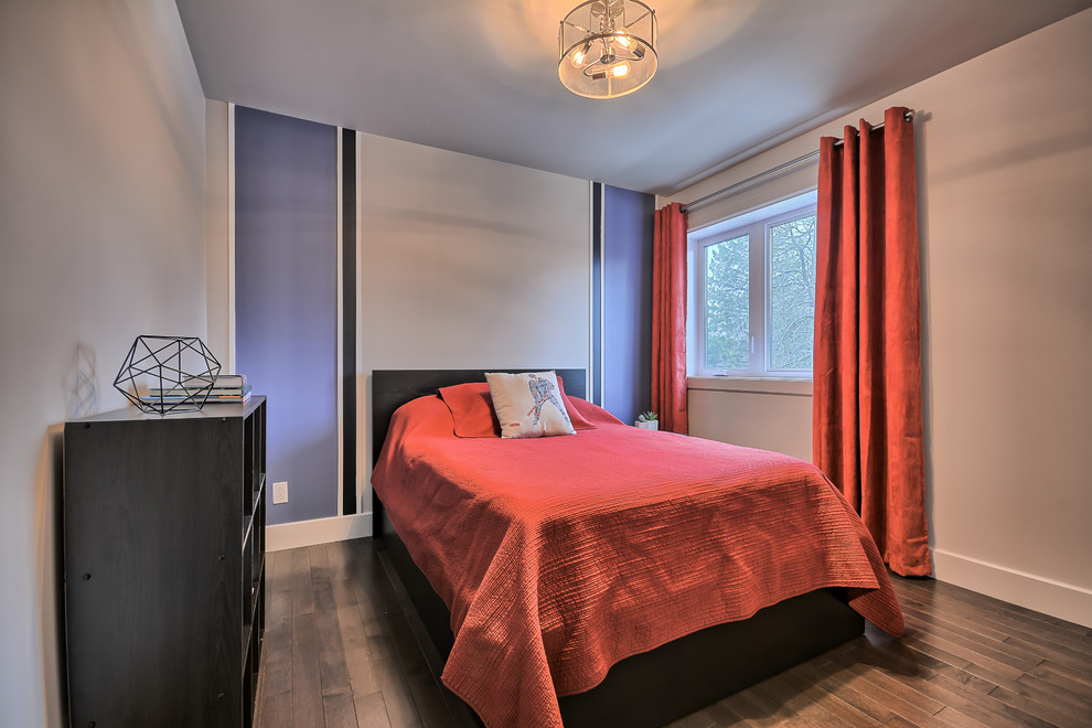 Medium sized contemporary bedroom in Montreal with blue walls, medium hardwood flooring, no fireplace and brown floors.