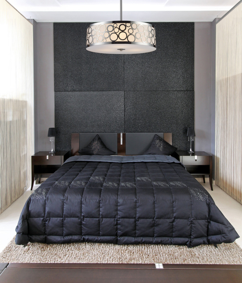 Example of a small 1950s guest light wood floor bedroom design in New York with black walls and no fireplace