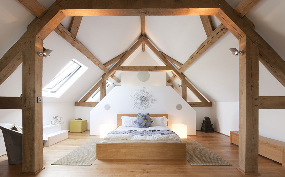 Large farmhouse light wood floor and beige floor bedroom photo in Sussex with white walls and no fireplace