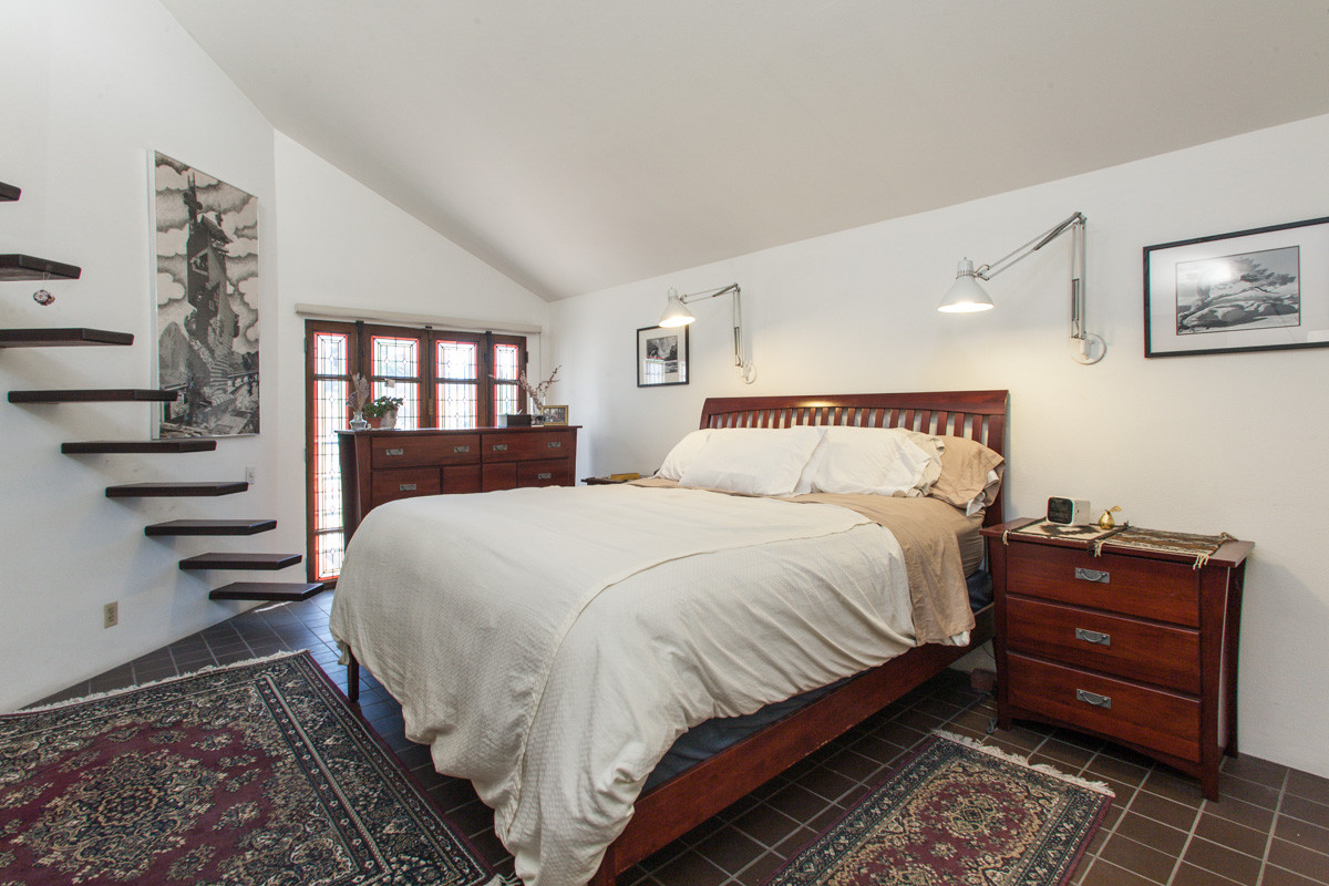 maroon bedroom with dark wood furniture