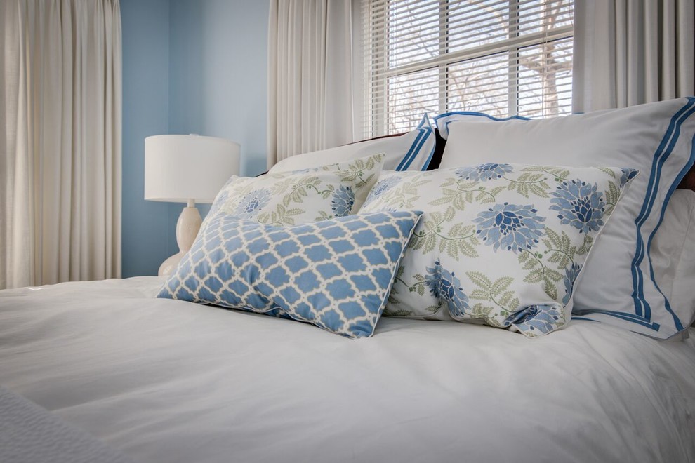 This is an example of a small classic guest bedroom in Charlotte with blue walls and carpet.
