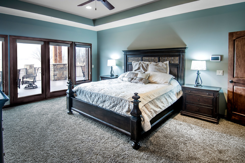 Design ideas for a medium sized classic master bedroom in Omaha with blue walls, carpet, no fireplace and brown floors.