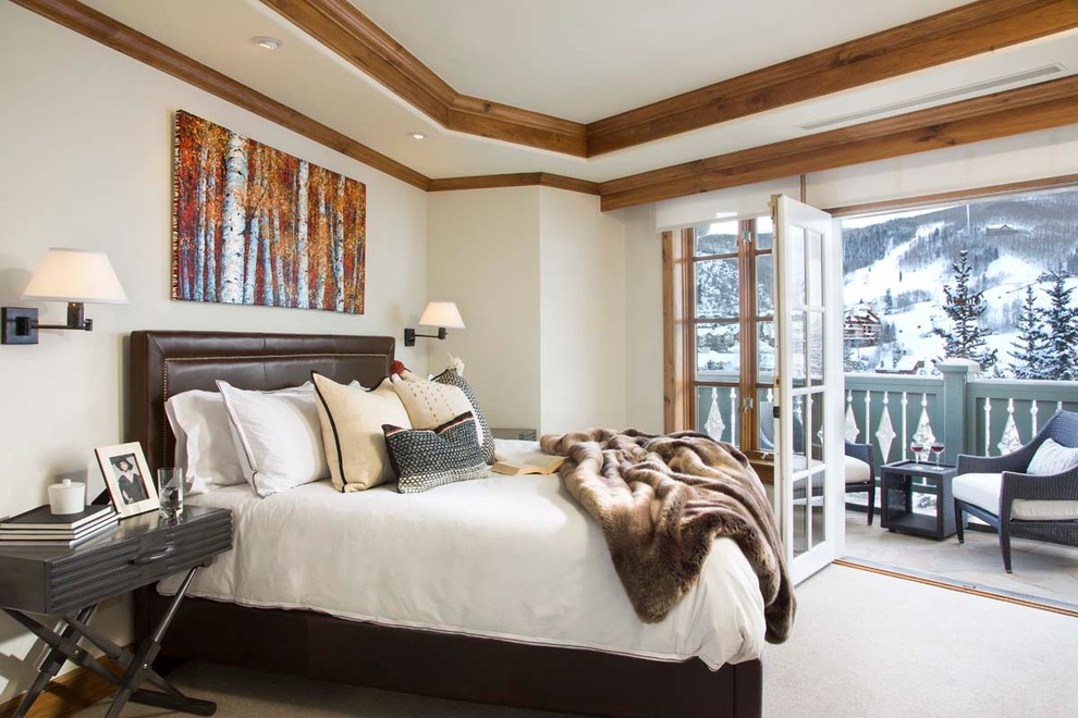 Inspiration for a large rustic master bedroom in Denver with white walls, carpet and no fireplace.