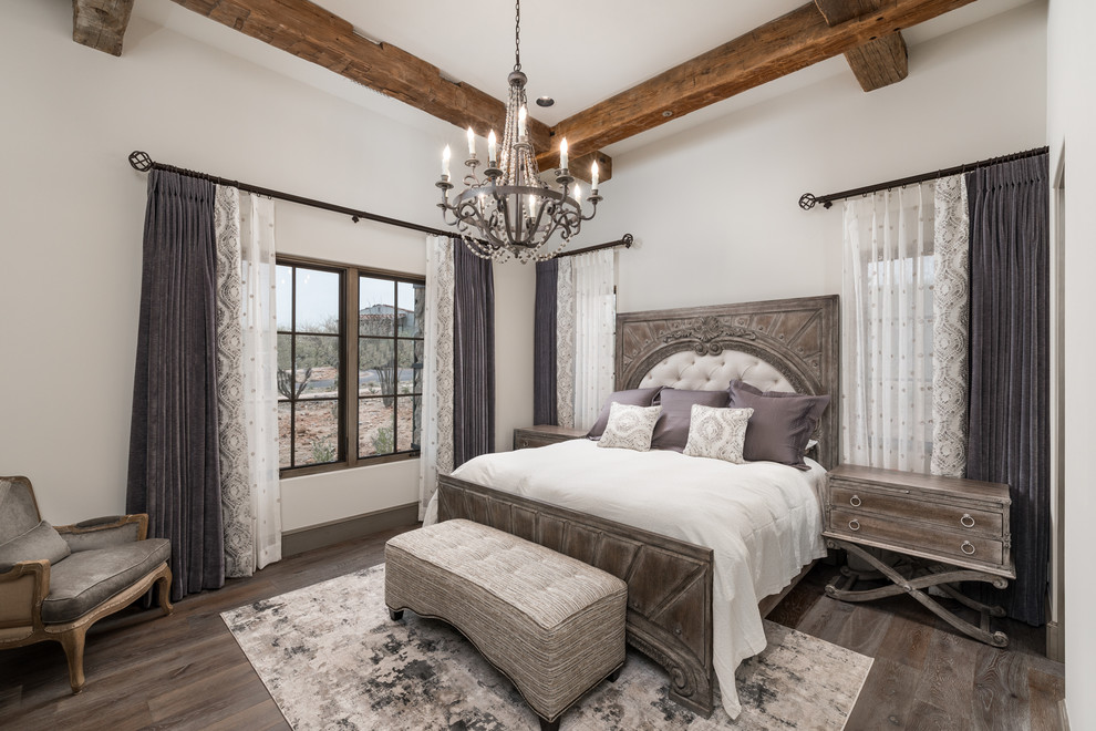 Design ideas for an expansive master bedroom in Phoenix with white walls, medium hardwood flooring, a two-sided fireplace, a stone fireplace surround and brown floors.