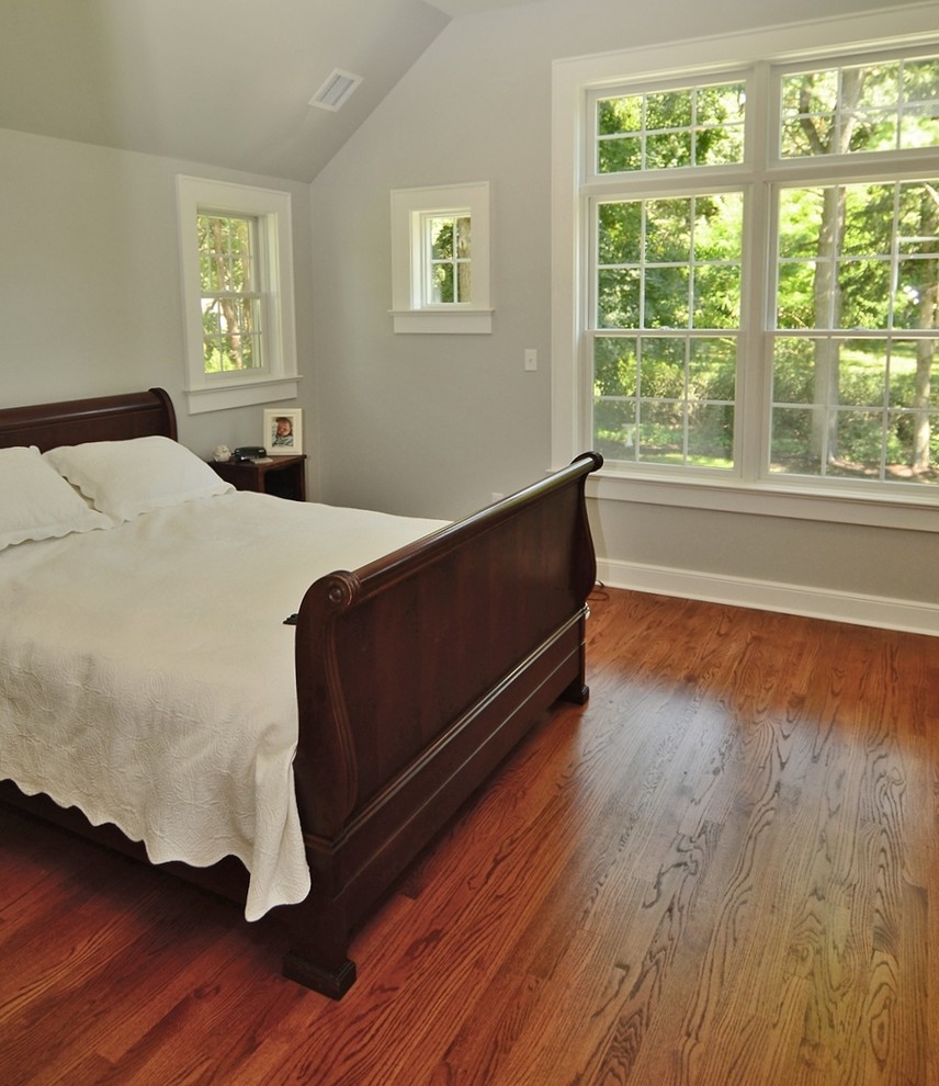 Photo of a medium sized classic master bedroom in New York with grey walls, medium hardwood flooring and no fireplace.