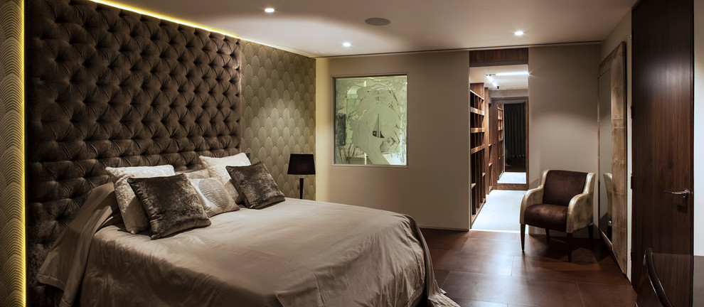 Expansive contemporary master bedroom in London with porcelain flooring.