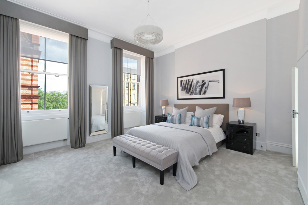 Large classic bedroom in London with grey walls, carpet and grey floors.
