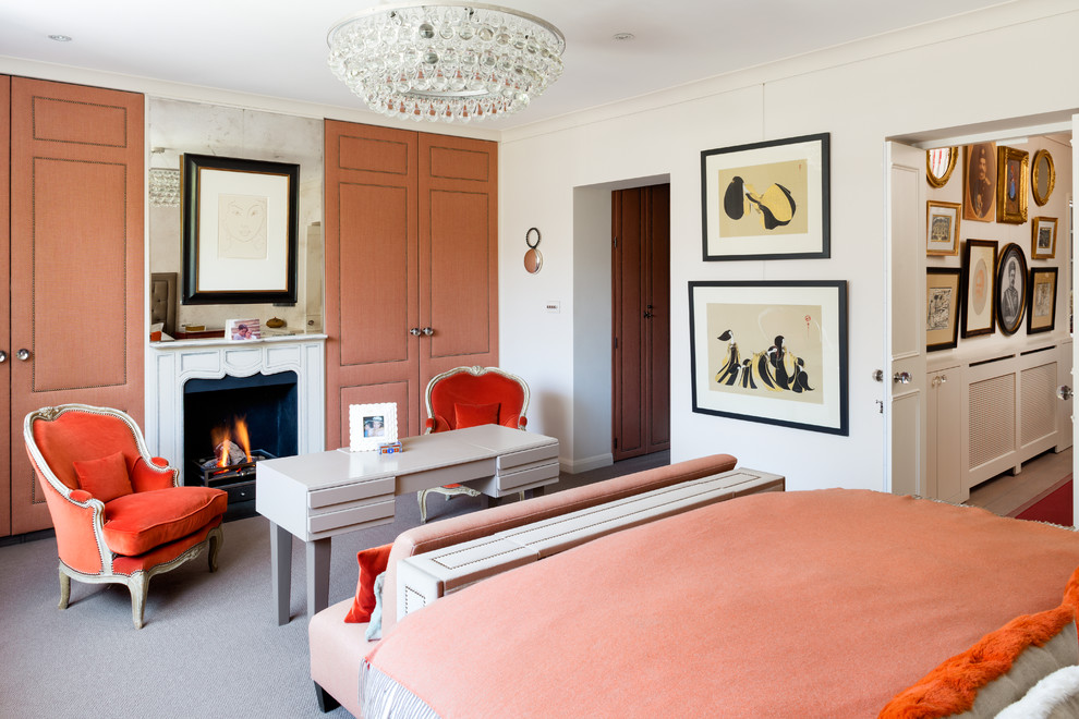 Photo of a contemporary bedroom in London with white walls, carpet and a standard fireplace.