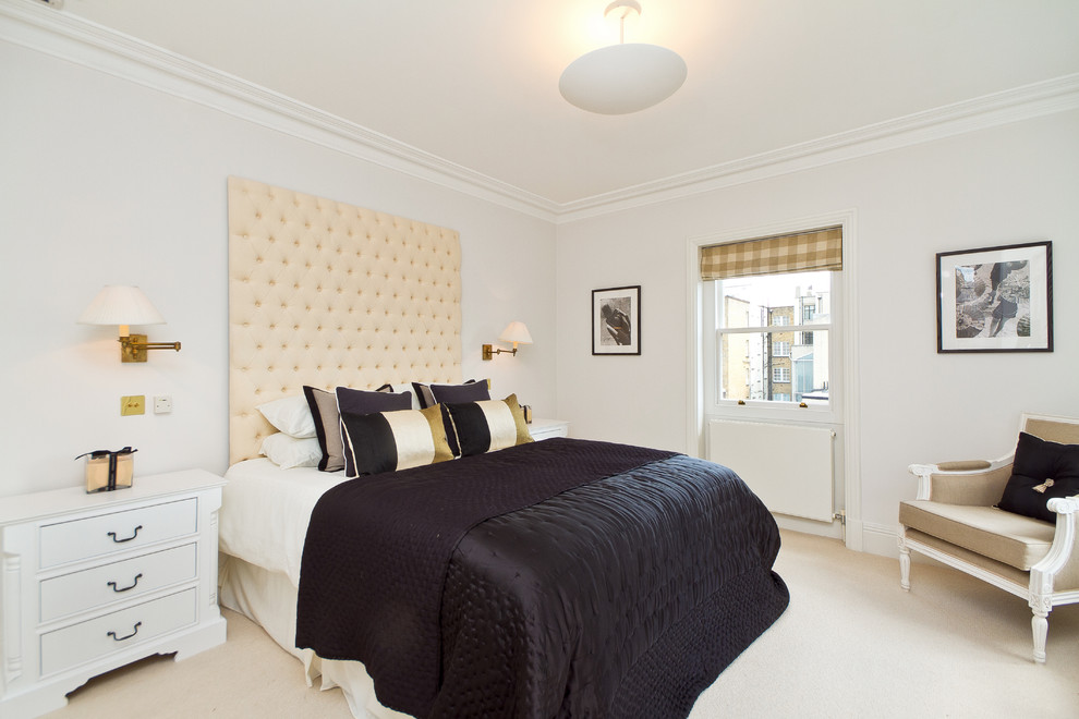 Design ideas for a contemporary bedroom in London with beige walls and carpet.