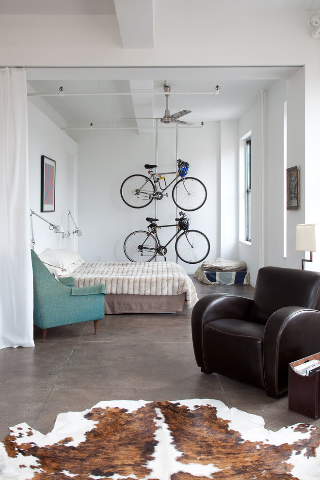 Inspiration for an industrial concrete floor bedroom remodel in New York