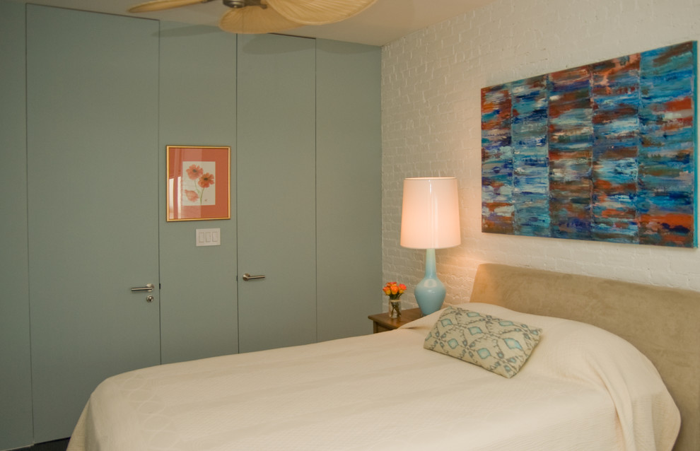 Example of a mid-sized eclectic master bedroom design in New York with blue walls