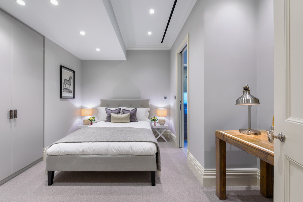 Large contemporary guest bedroom in London with grey walls, carpet, no fireplace and grey floors.