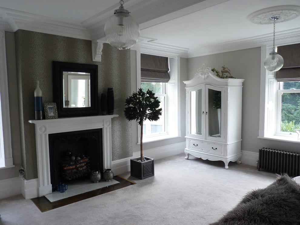 Photo of a large traditional master bedroom in Other with grey walls, carpet, a standard fireplace and a wooden fireplace surround.