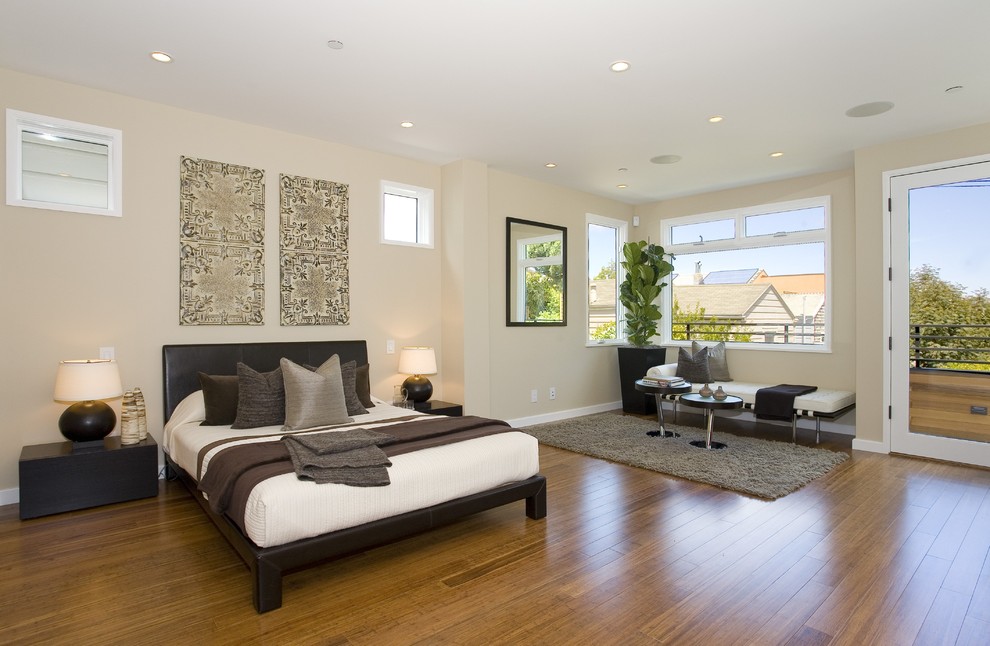 Trendy medium tone wood floor bedroom photo in San Francisco with beige walls