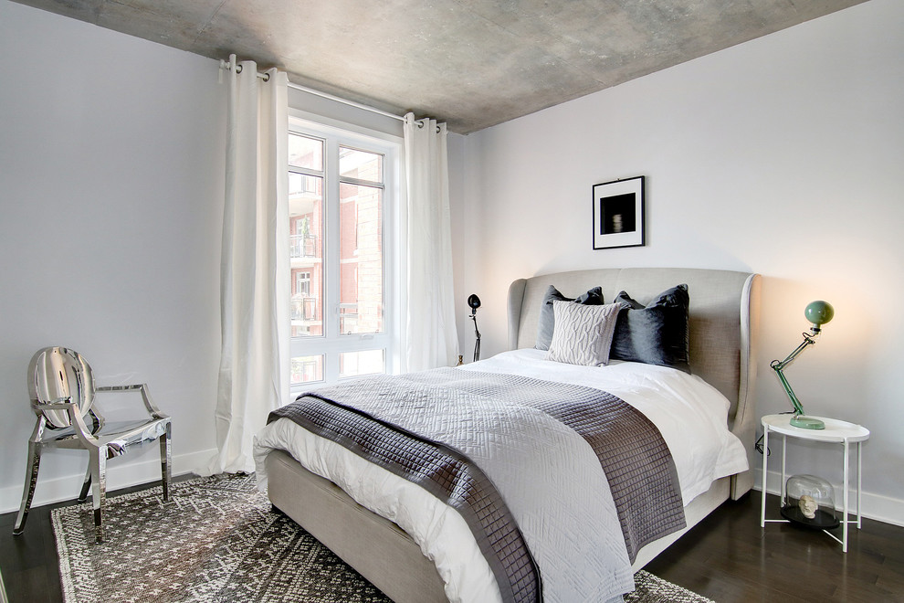 Contemporary guest, grey and brown and grey and silver bedroom in Montreal with grey walls, dark hardwood flooring and brown floors.