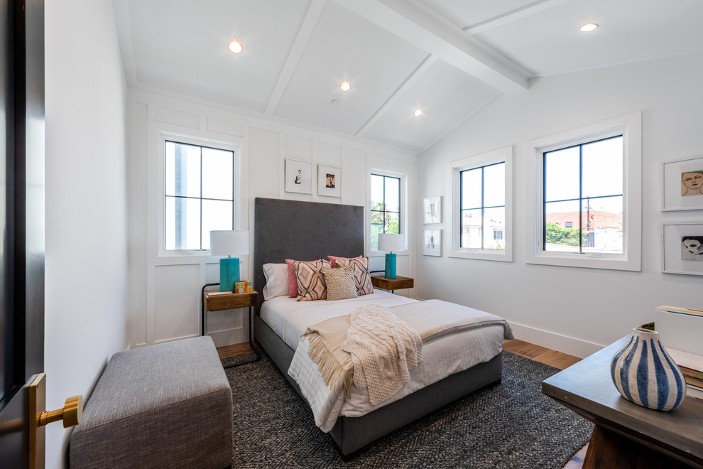Inspiration for a transitional medium tone wood floor and brown floor bedroom remodel in Los Angeles with white walls
