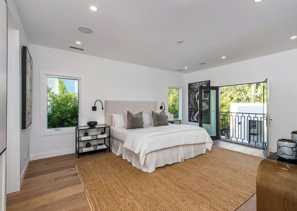 Inspiration for a large transitional master medium tone wood floor and beige floor bedroom remodel in Los Angeles with white walls