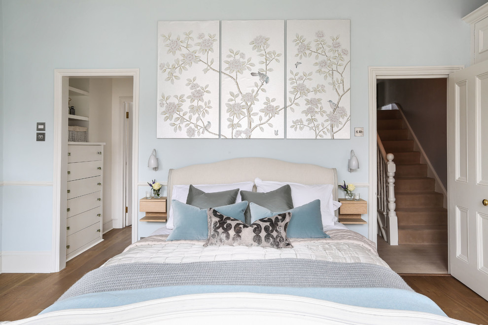 Bedroom - mid-sized transitional dark wood floor and brown floor bedroom idea in London with blue walls