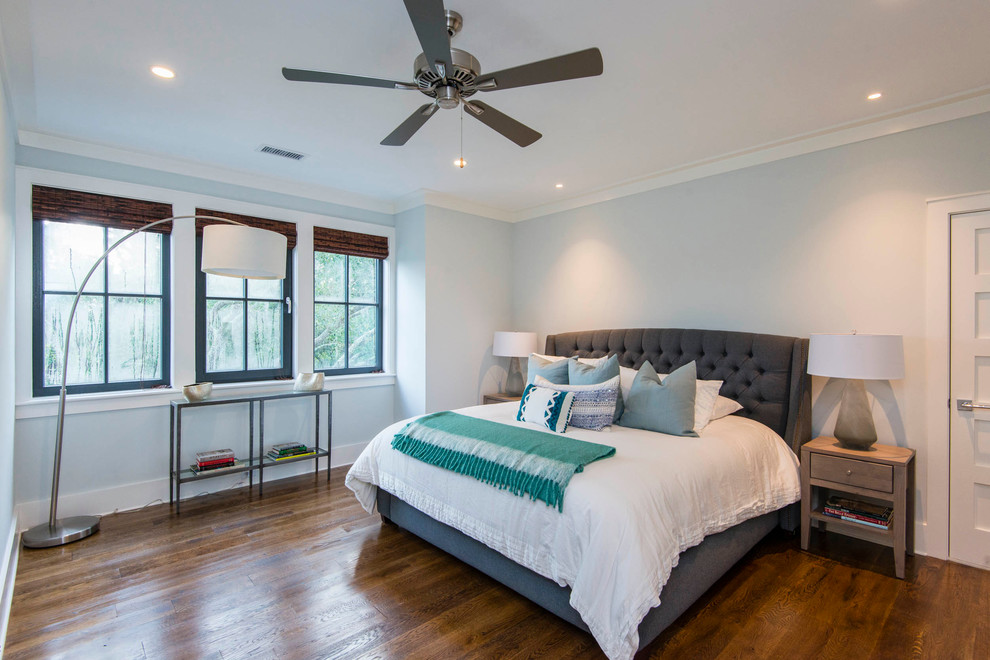 Transitional master medium tone wood floor bedroom photo in Charleston with blue walls