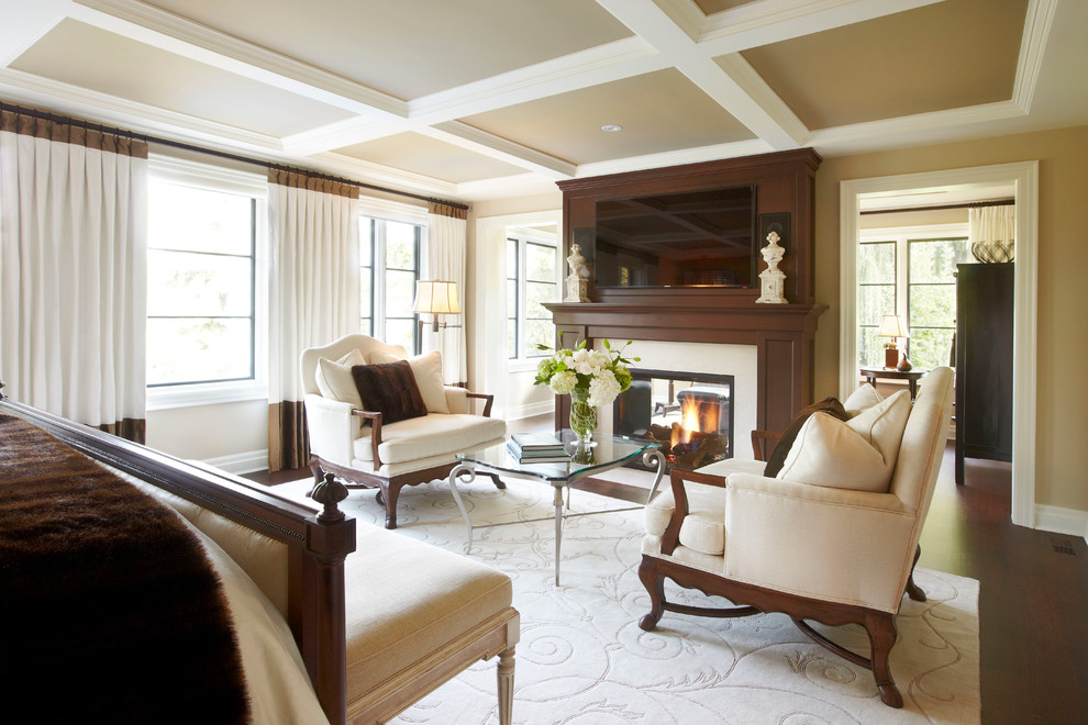 Design ideas for a large traditional master bedroom in Toronto with beige walls and a two-sided fireplace.