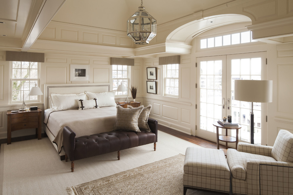 Large traditional master bedroom in Dallas with white walls, dark hardwood flooring and brown floors.